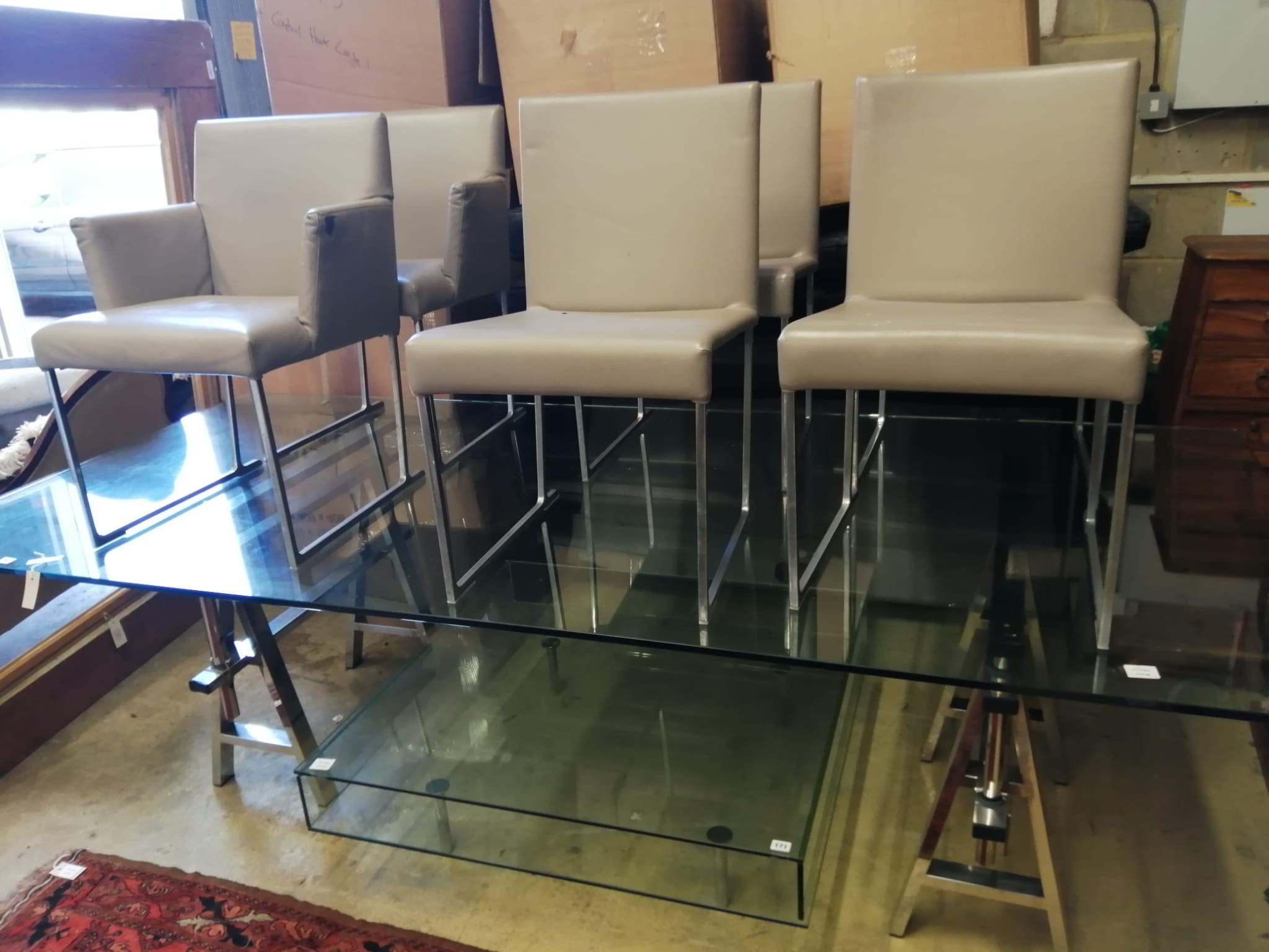 A contemporary glass top stainless steel framed rectangular dining table, length 270cm, width 120cm, height 72cm, and six B & B Italia leather dining chairs, two with arms